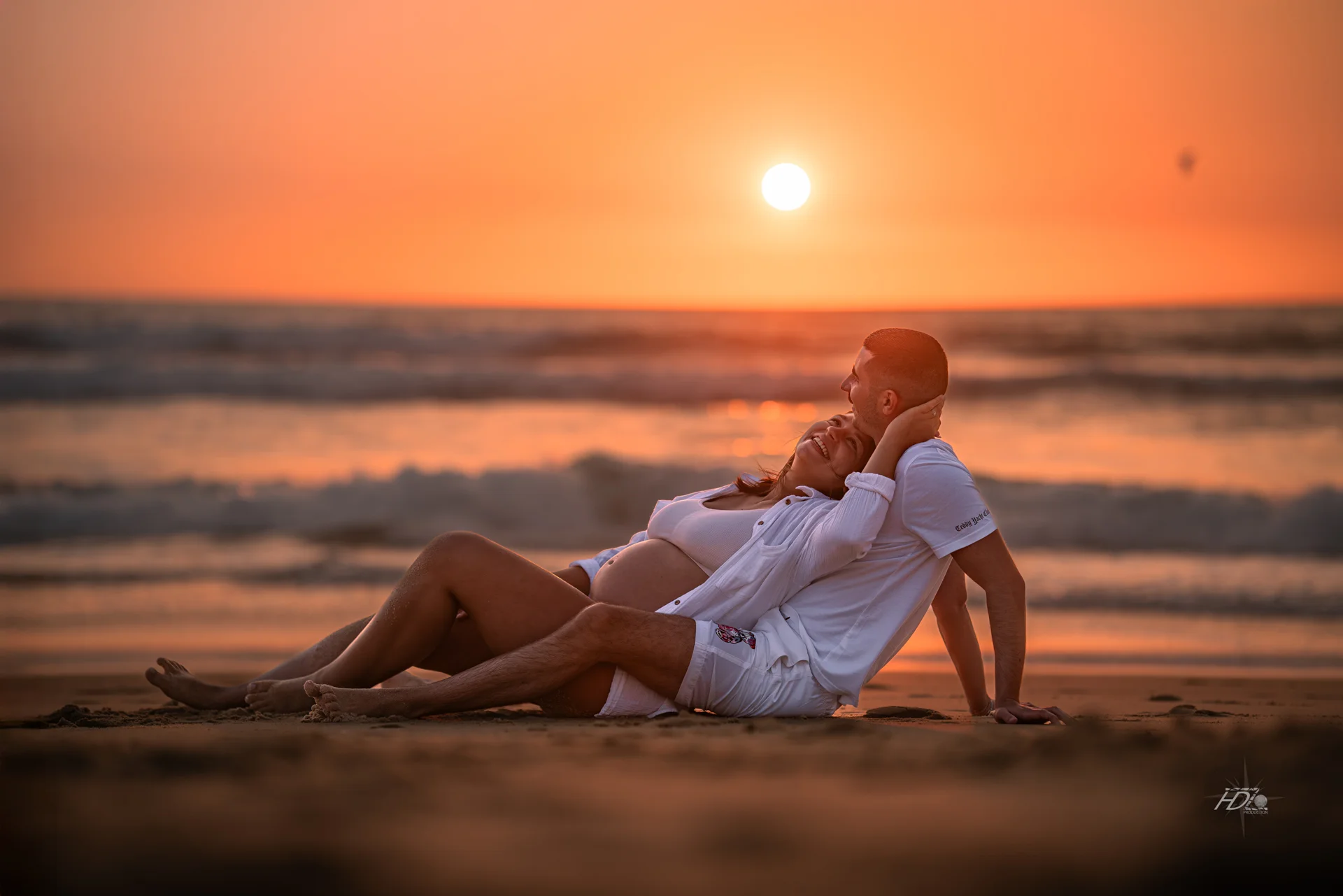 Un couple lors d'une séance photo grossesse à la plage à Arcachon